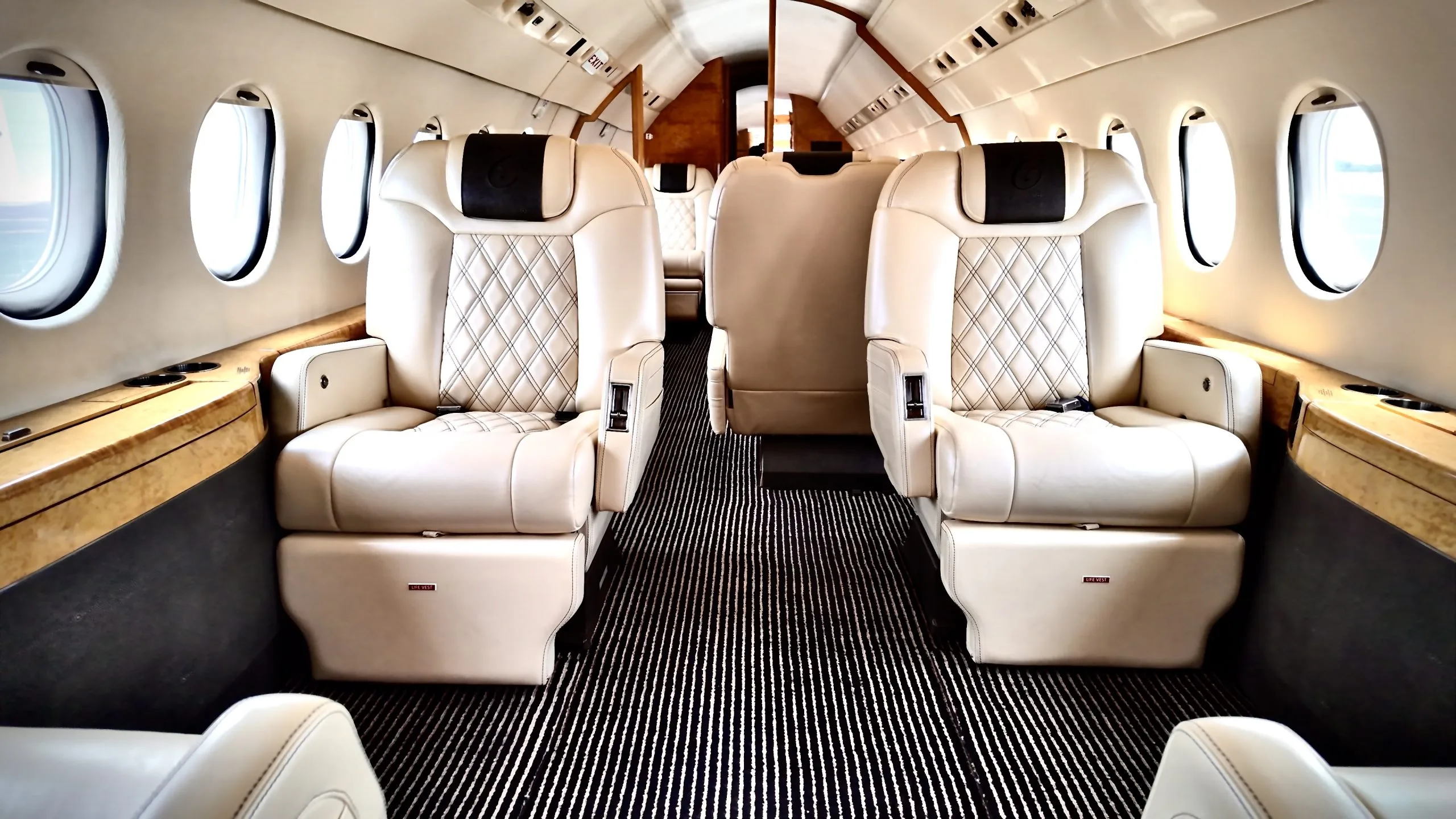 Falcon 900EX cabin interior with earth-tone leather executive seating